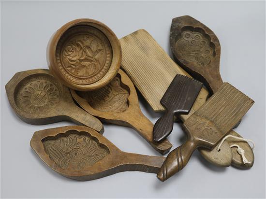A collection of 19th century treen butter pats, biscuit moulds, etc.